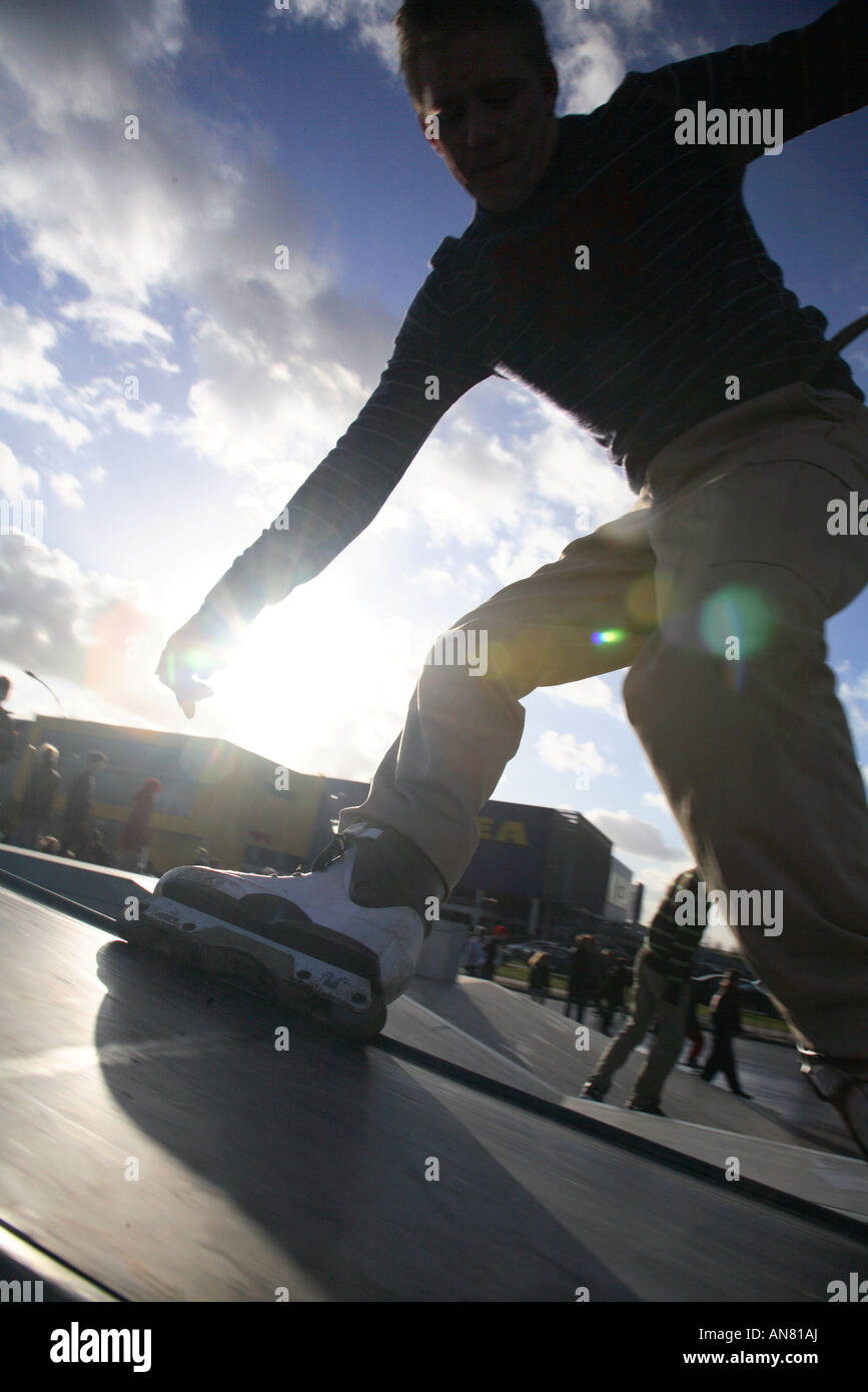 inline skater with inline skates doing tricks at skatepark Stock Photo