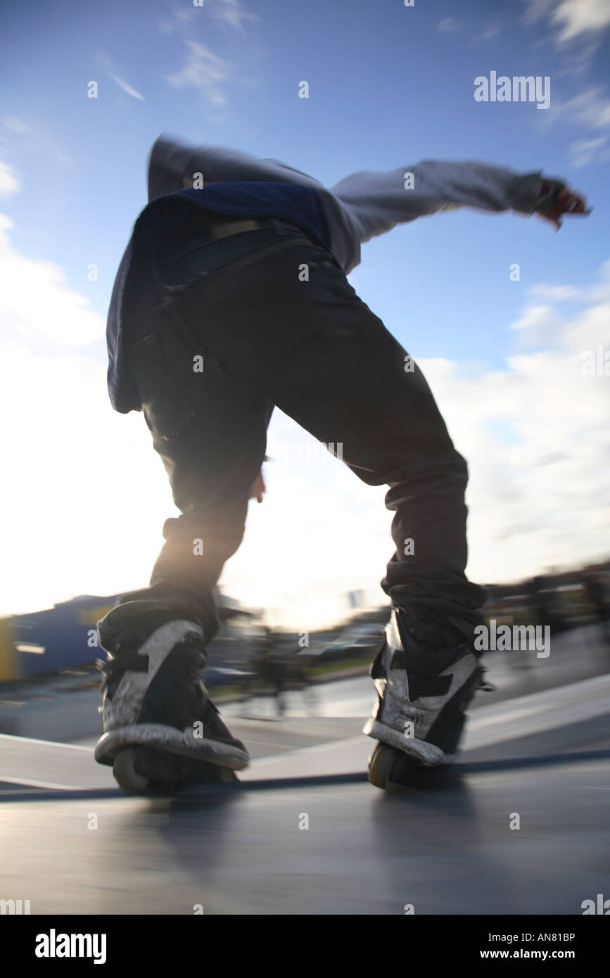 inline skater with inline skates doing tricks at skatepark Stock Photo