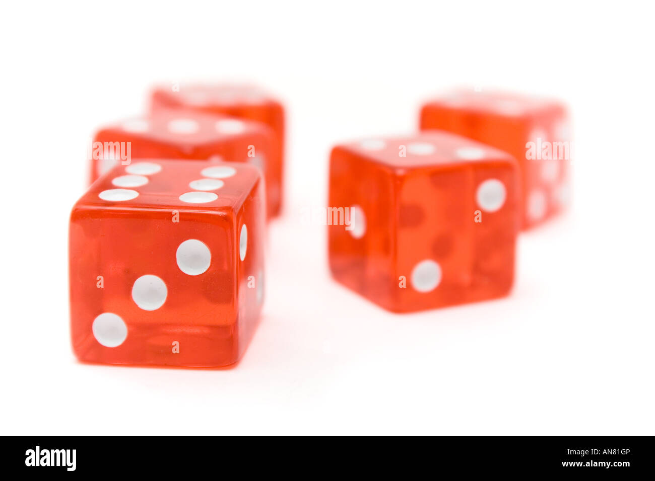 Translucent red dice isolated on a white background. Shallow depth of field. Stock Photo