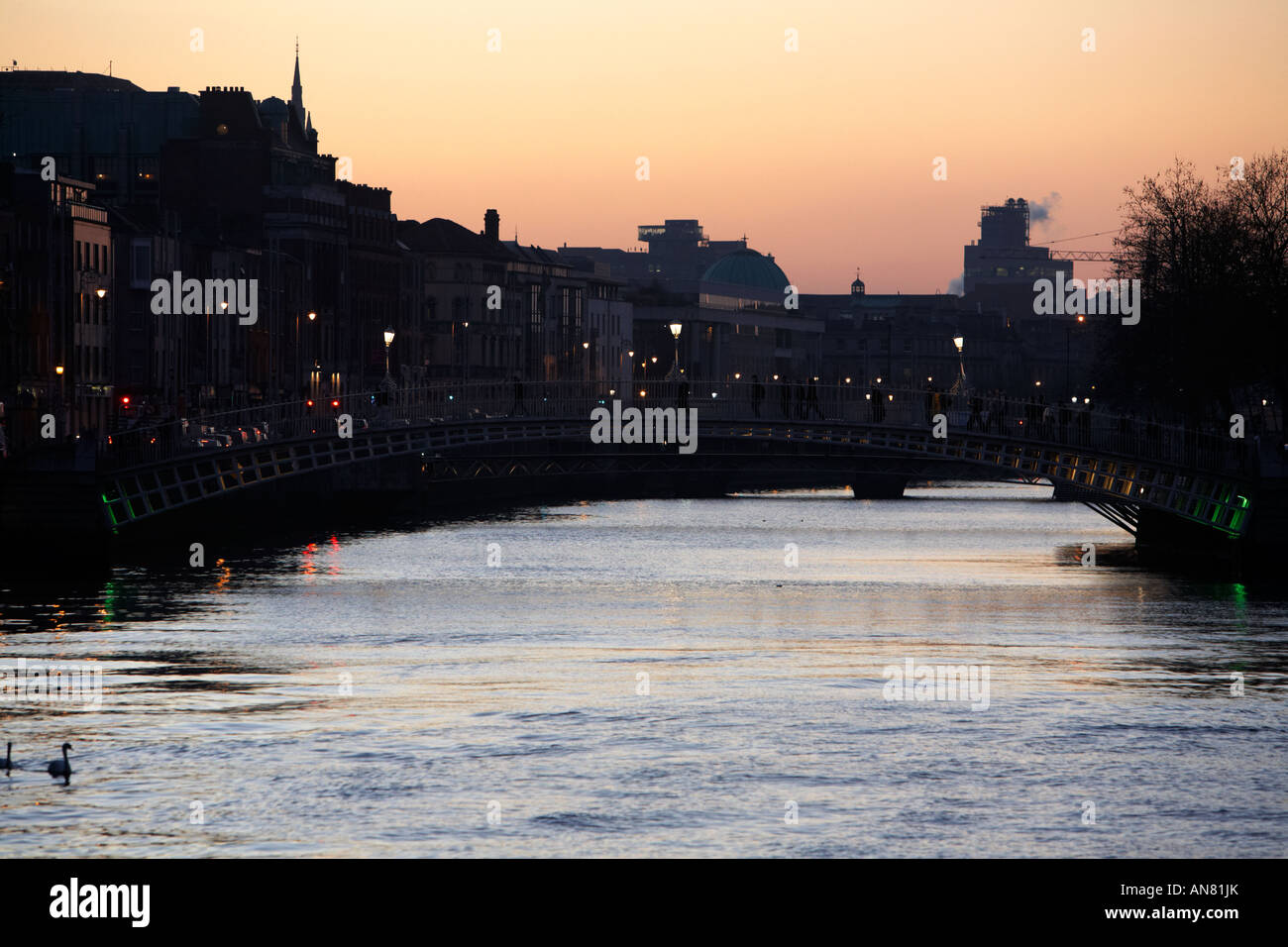 The river liffey and halfpenny bridge at dusk Dublin Republic of ...