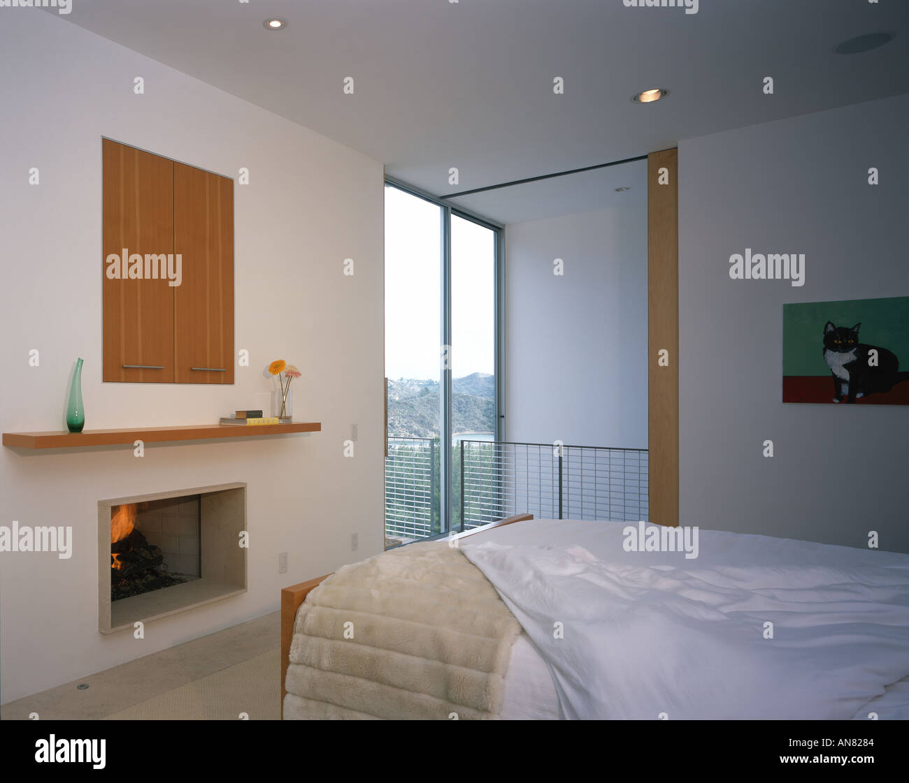 Oshry Residence, Bel Air, California. Bedroom with fireplace. Architect: SPF Architects Stock Photo