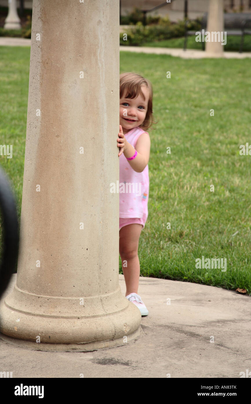 Little Girl Playing Peek-A-Boo Stock Photo