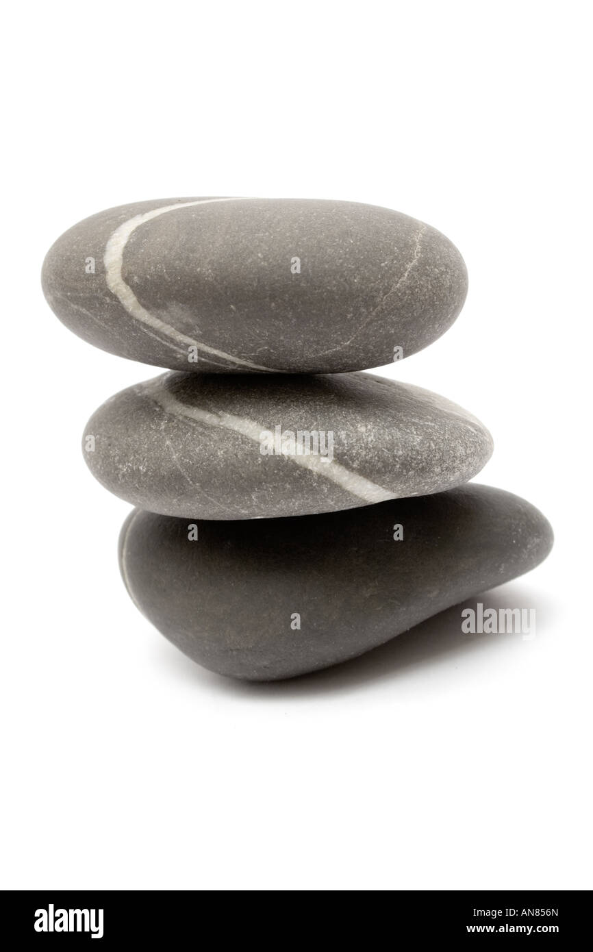 Three gray stones stacked on each other. Isolated on a white background ...