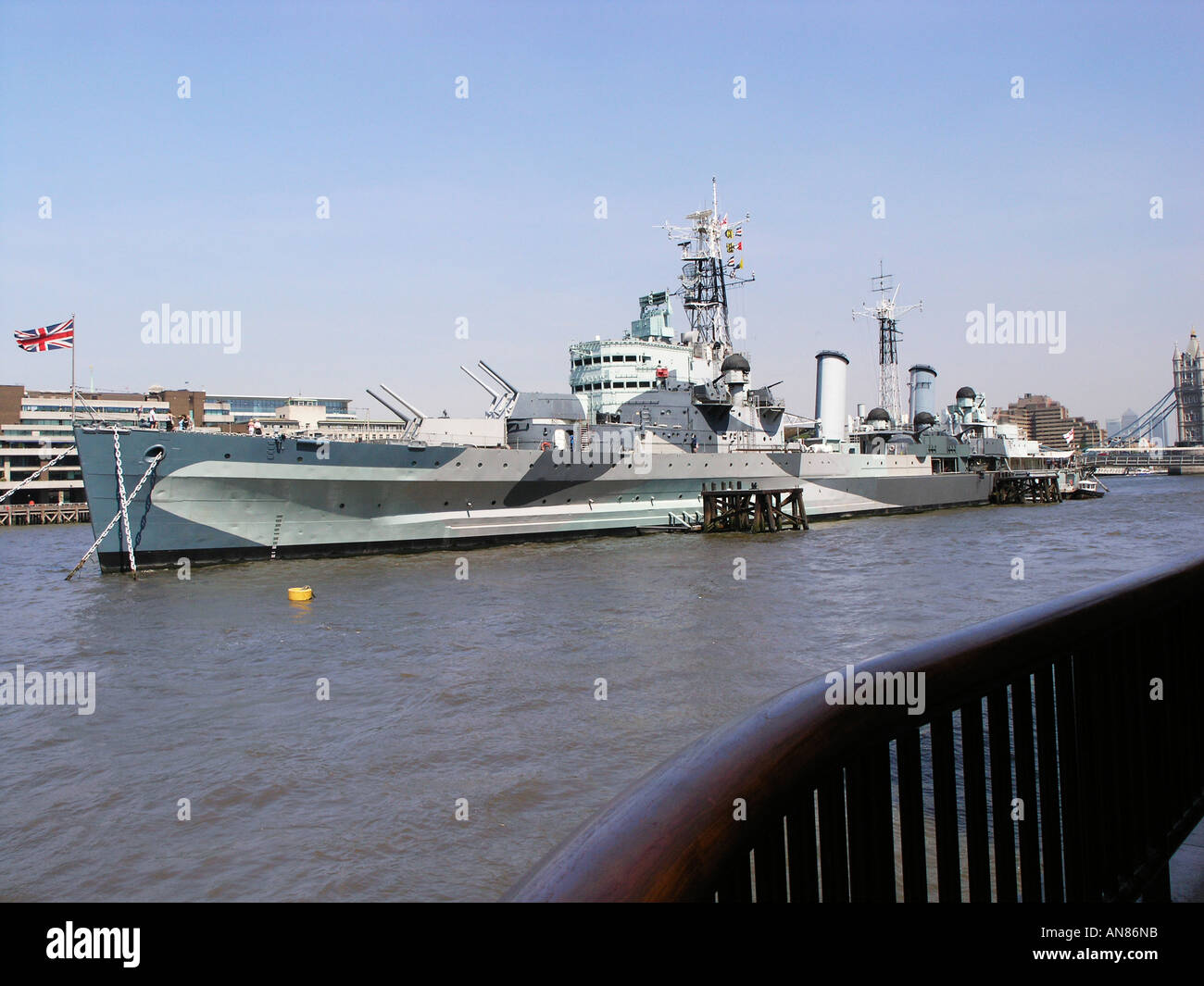 HMS Belfast, a Town Class Cruiser, moored on the south bank of the Thames just upstream from Tower Bridge. Stock Photo