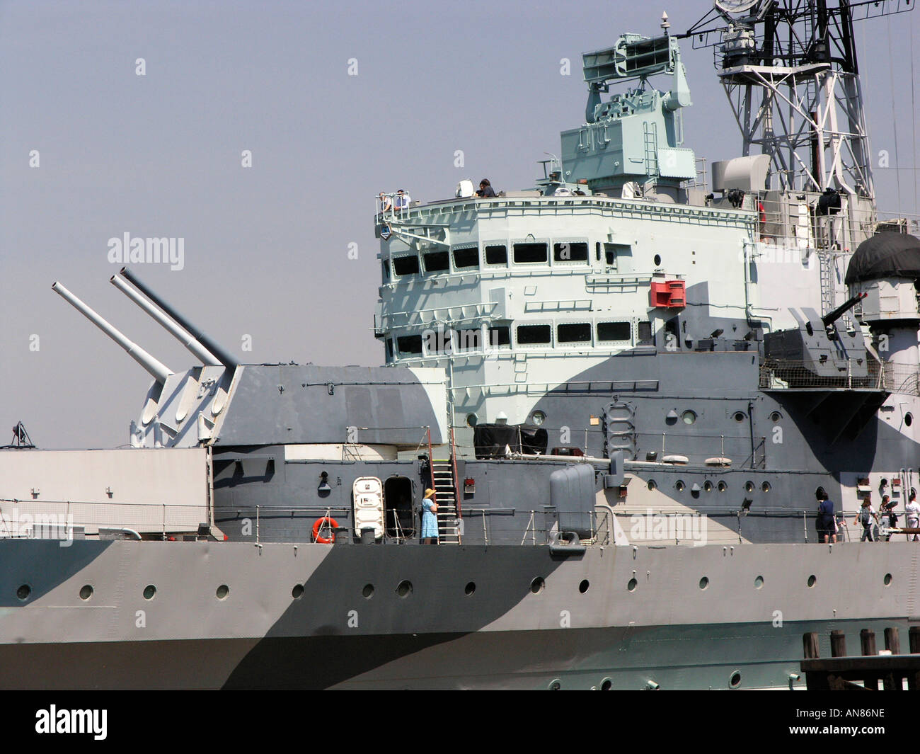 HMS Belfast, a Town Class Cruiser, moored on the south bank of the Thames just upstream from Tower Bridge. Stock Photo