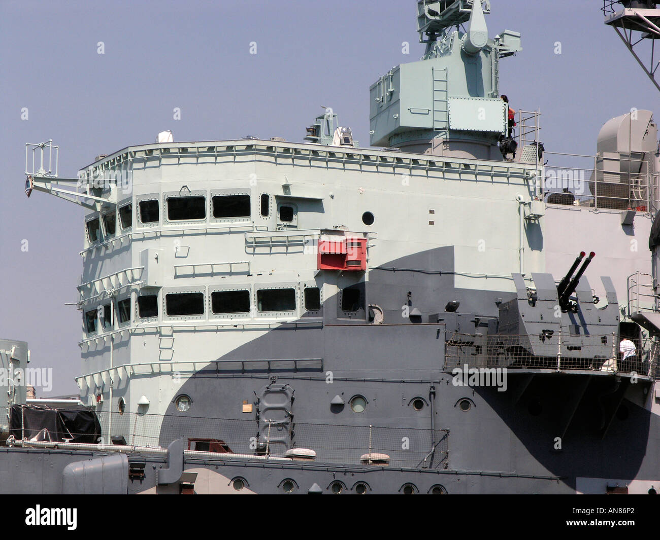 HMS Belfast, a Town Class Cruiser, moored on the south bank of the Thames just upstream from Tower Bridge. Stock Photo