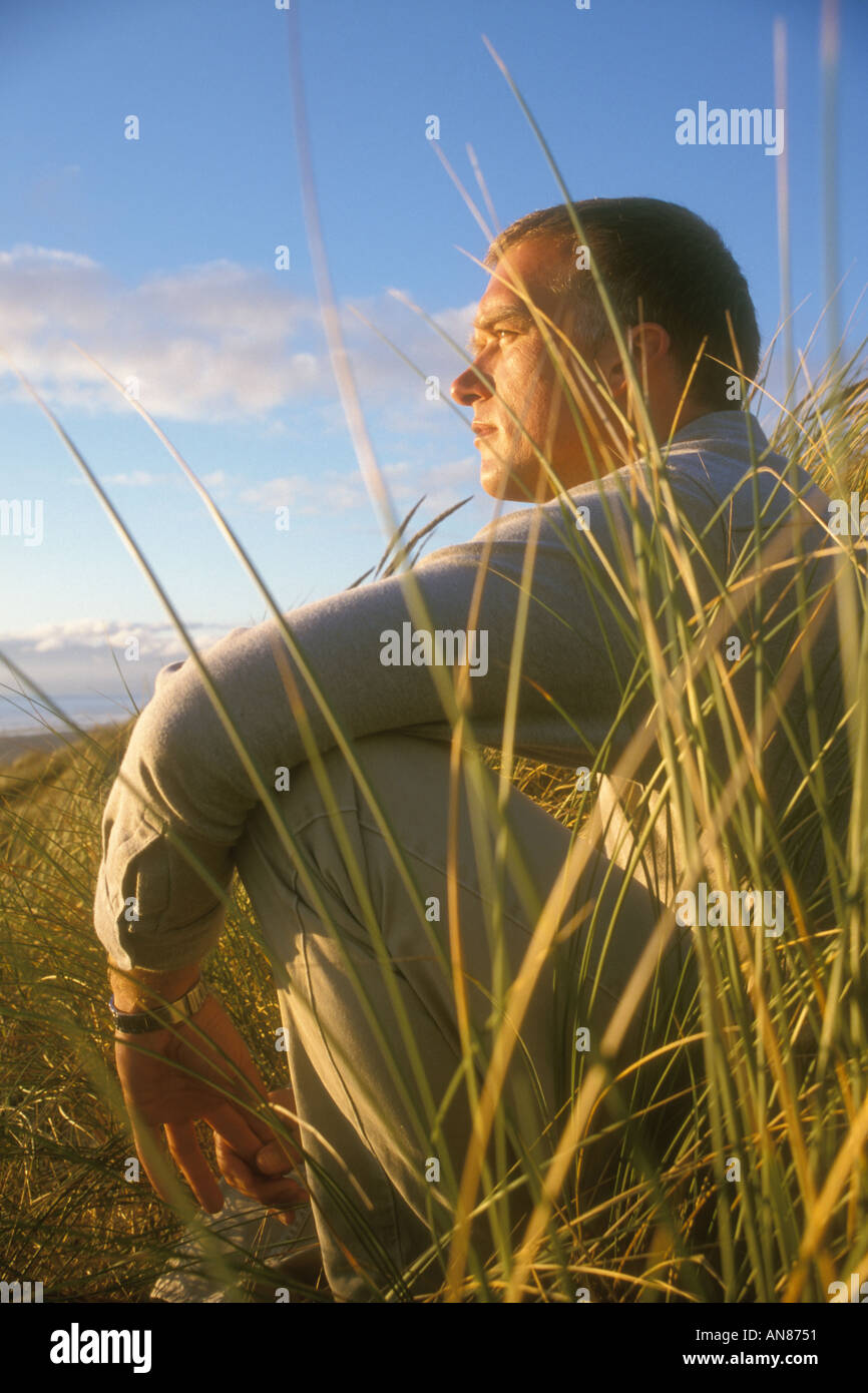 33 year old Lithuanian descent Caucasian male sitting in "tall grass" Stock Photo