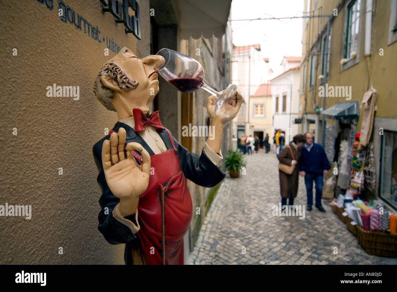 SINTRA PORTUGAL Humorous woodcarving of sommelier tasting red wine advertises a restaurant Stock Photo
