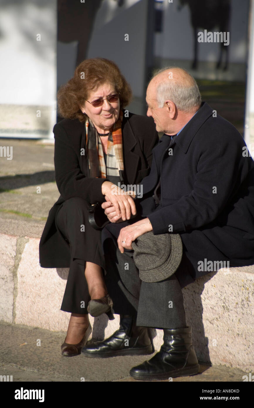 LISBON PORTUGAL Middle aged couple holds hands and converses on grounds of Castelo de Sao Jorge St George s Castle Stock Photo