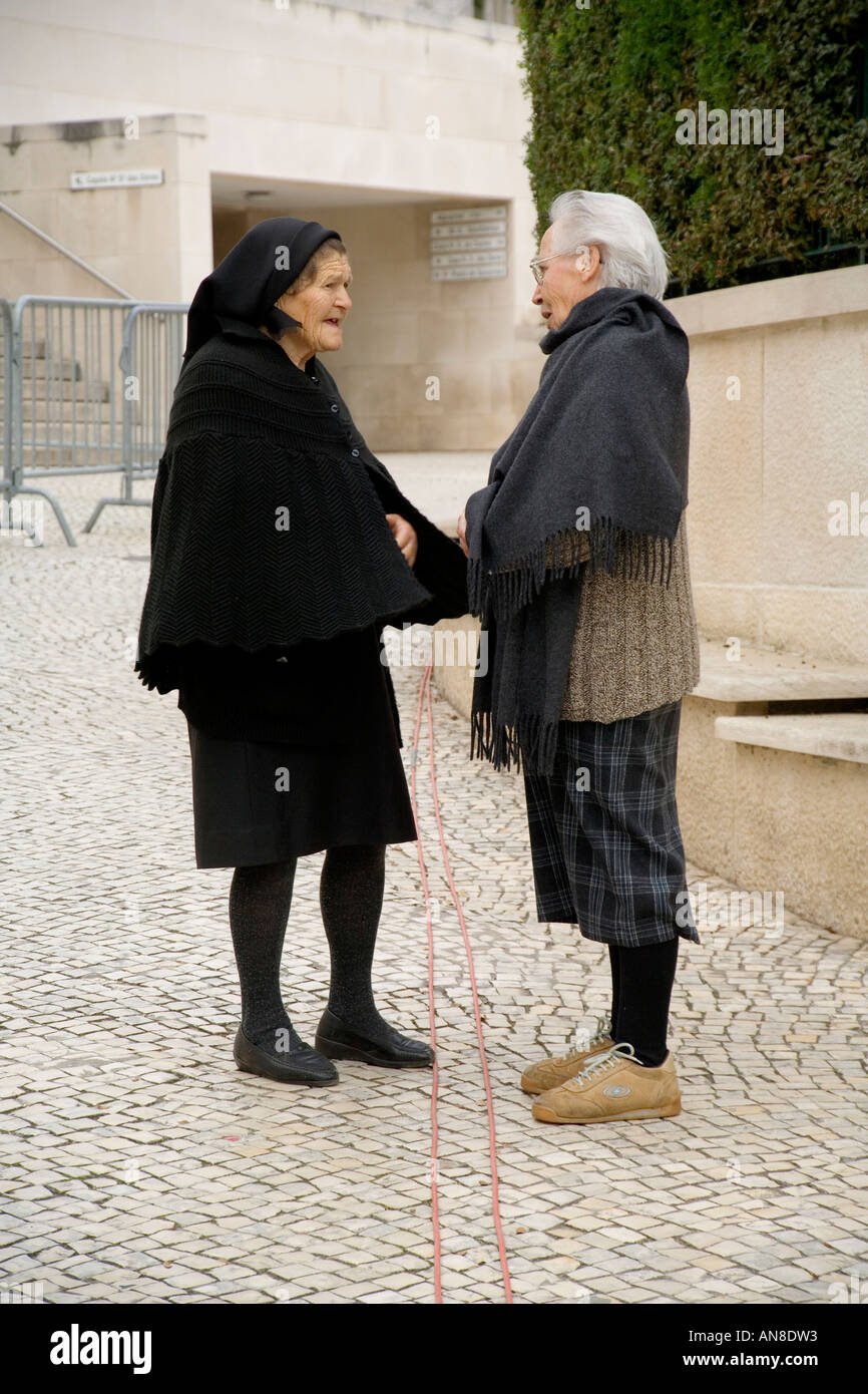 FATIMA PORTUGAL Widow chats with another woman at this world famous pilgrimage site Stock Photo