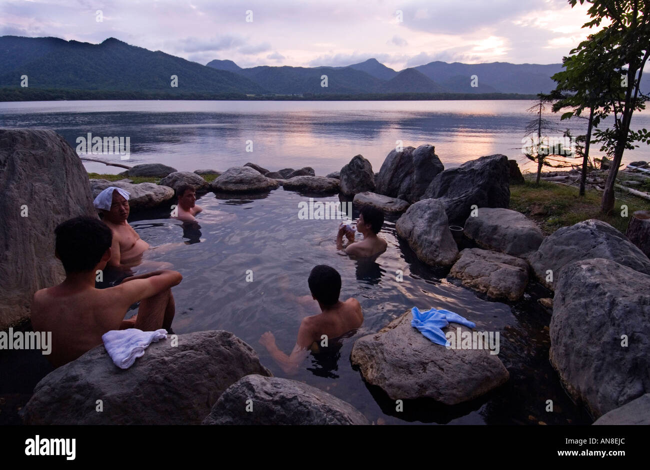 People bathing in outdoor rotemburo onsen on shore of Lake Akan in Akan National Park Hokkaido Stock Photo