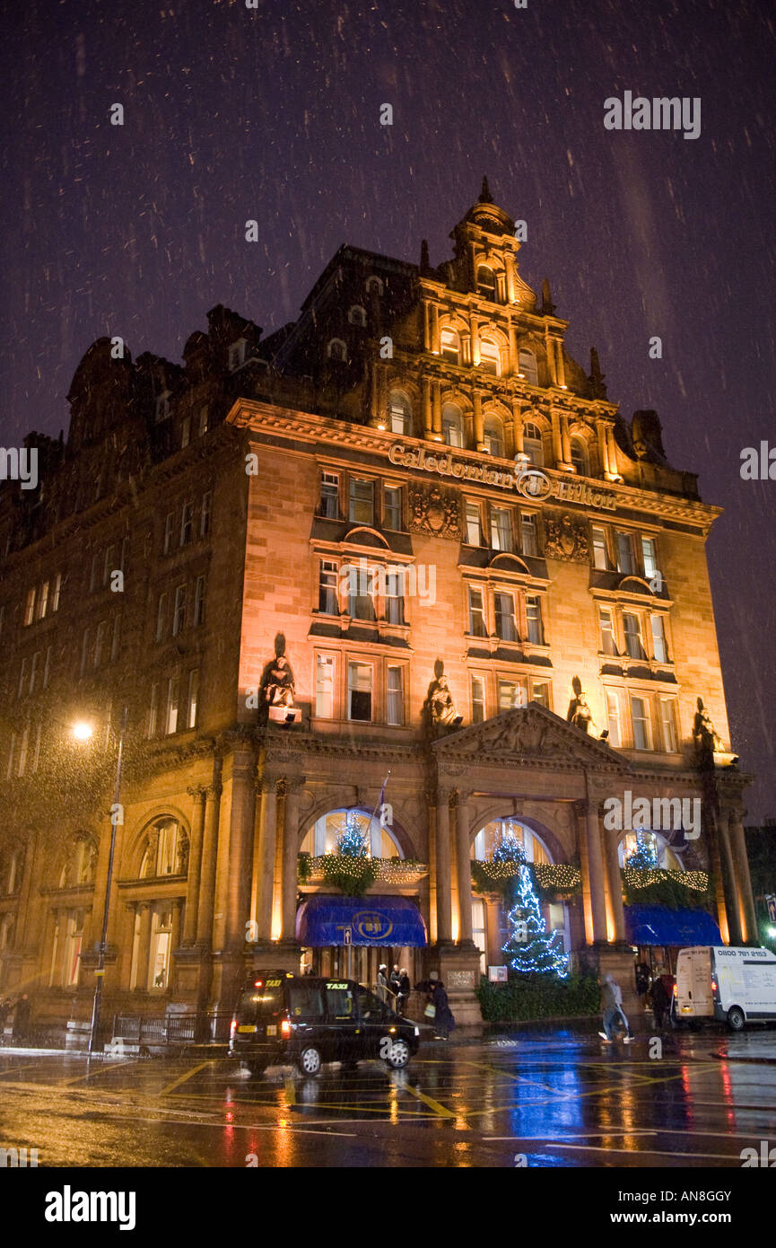 Caledonian Hilton Hotel Edinburgh floodlit in falling snow at Christmas