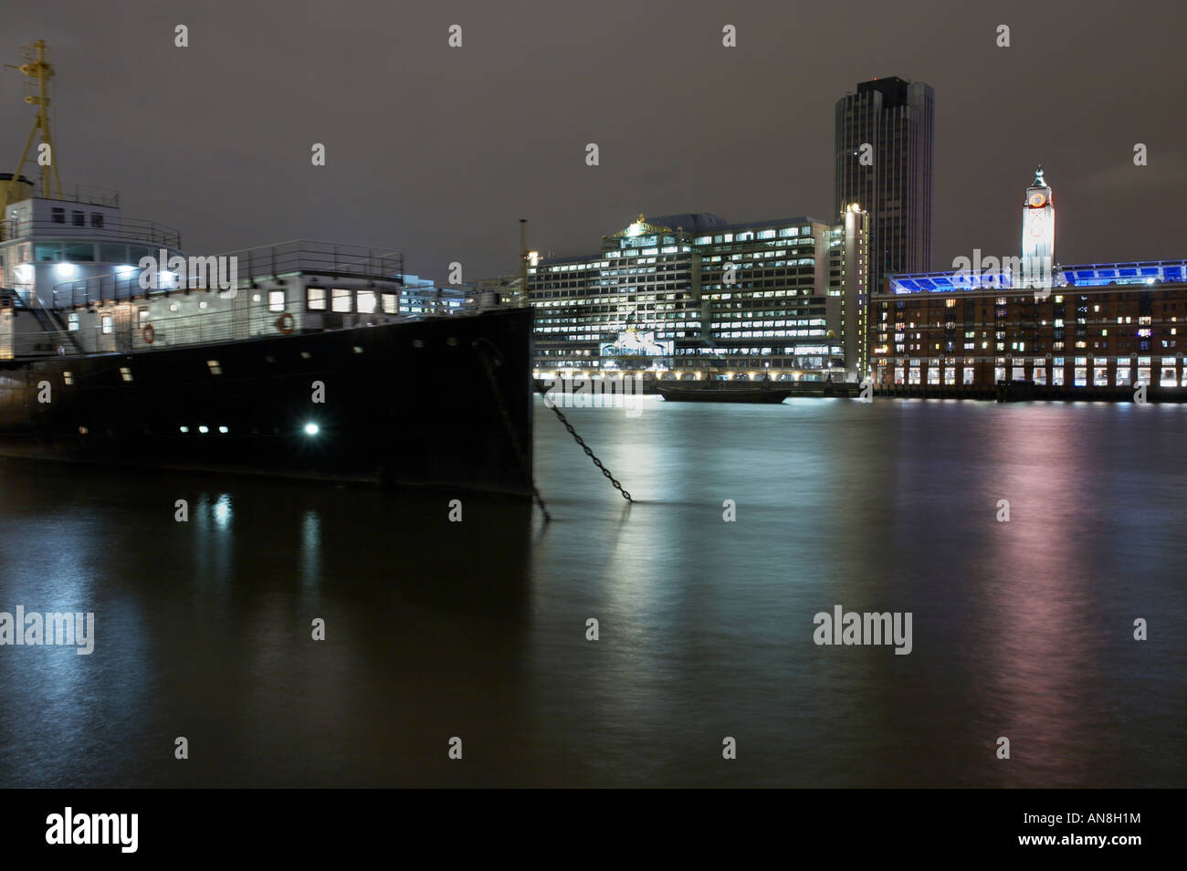 night view of River Thames and moored boat in London England UK Stock Photo