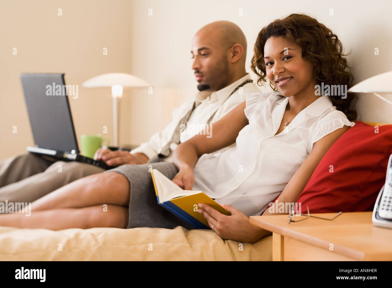 African couple relaxing in bed Stock Photo - Alamy
