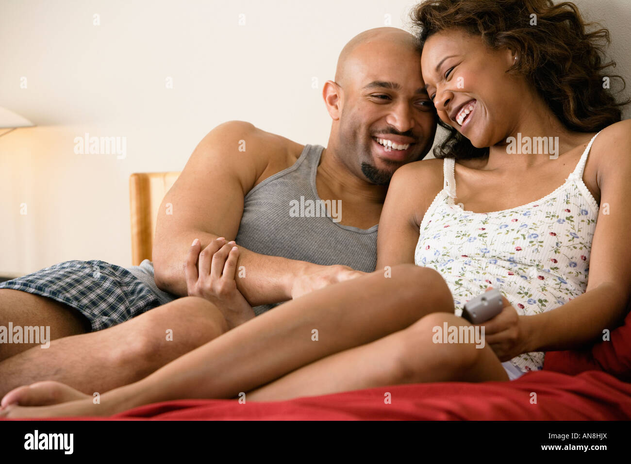 African couple cuddling in bed Stock Photo - Alamy