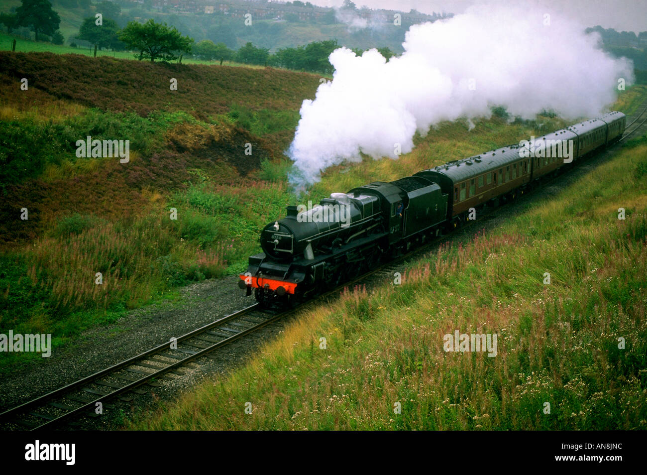 East Lancashire Railway A black steam train travels through the countryside Stock Photo