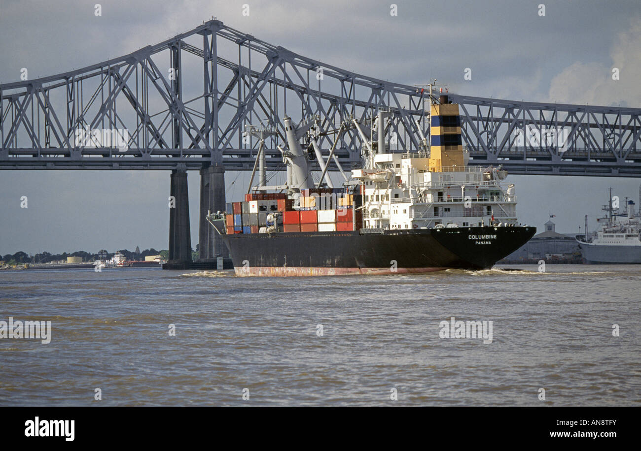 A large cargo ship or container ship heads down the Mississippi River