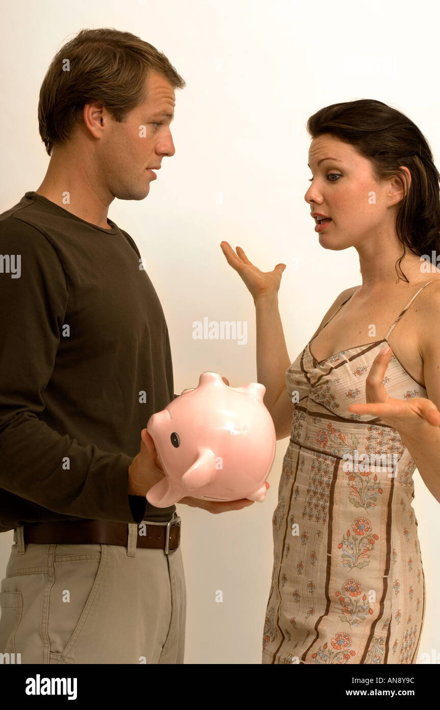 Portrait of a couple checking their piggy bank for money Stock Photo ...