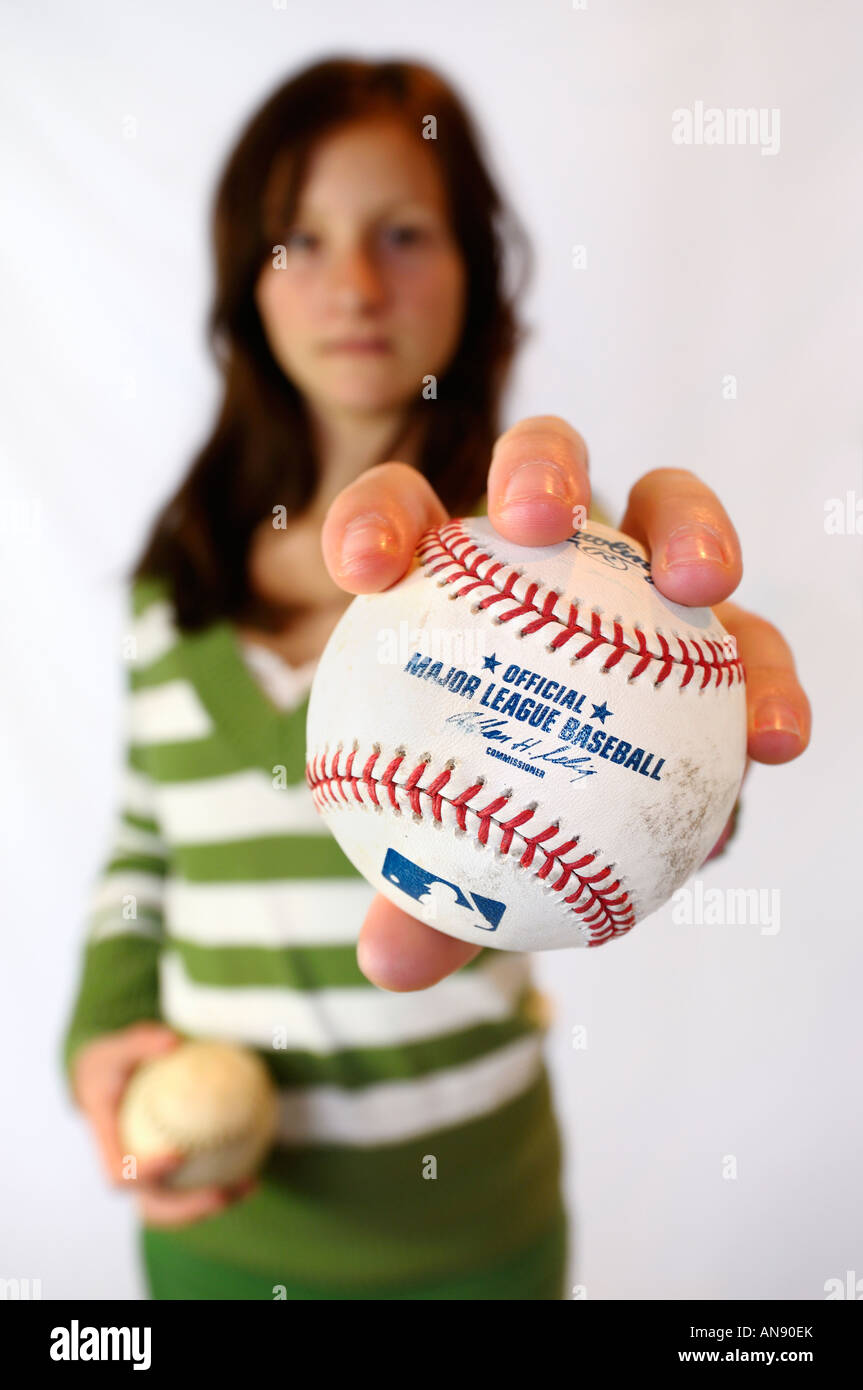 Young girl fan holding an official Major League Baseball signed ball