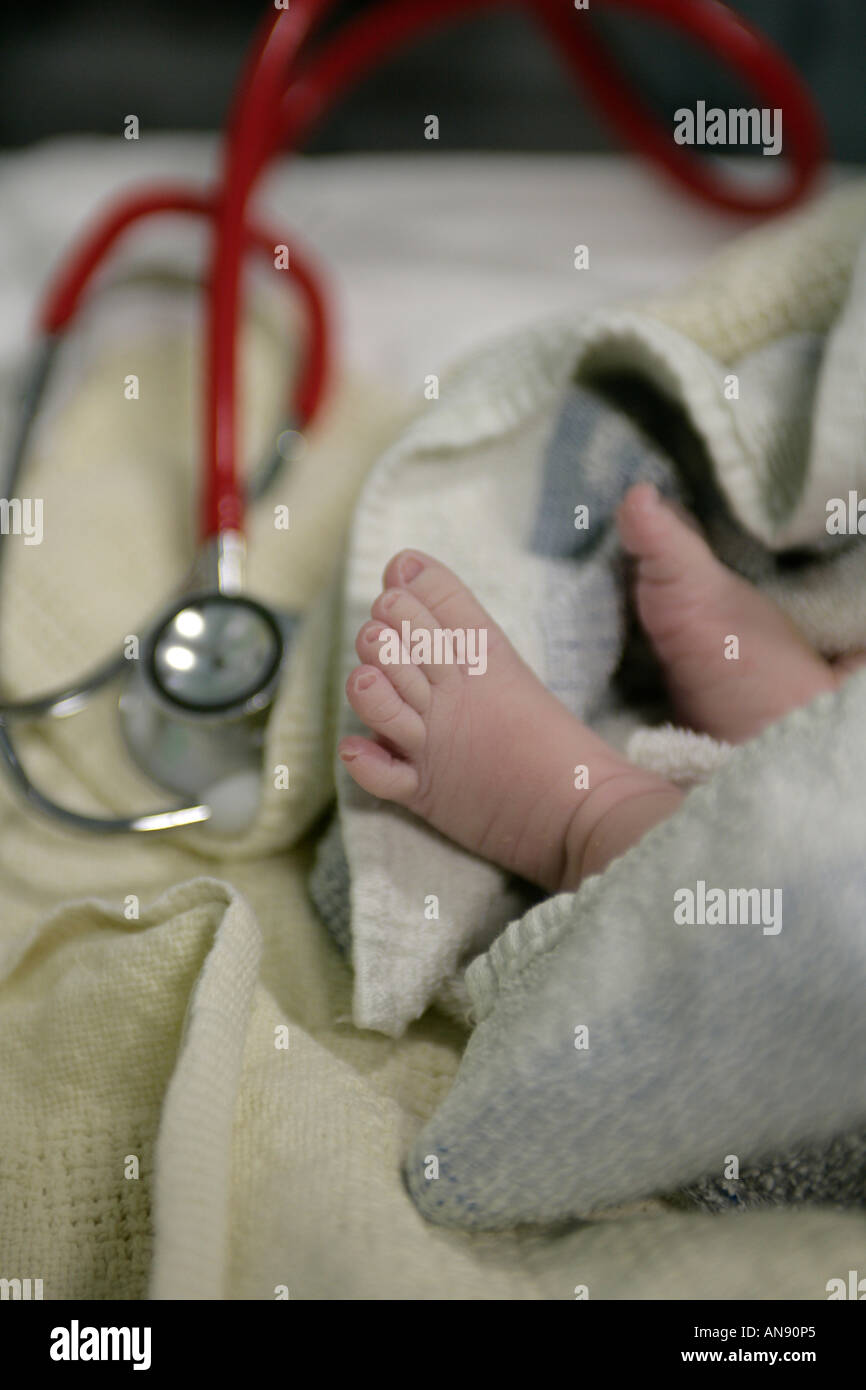 Newborn babys feet with a stetherscope red Stock Photo Alamy