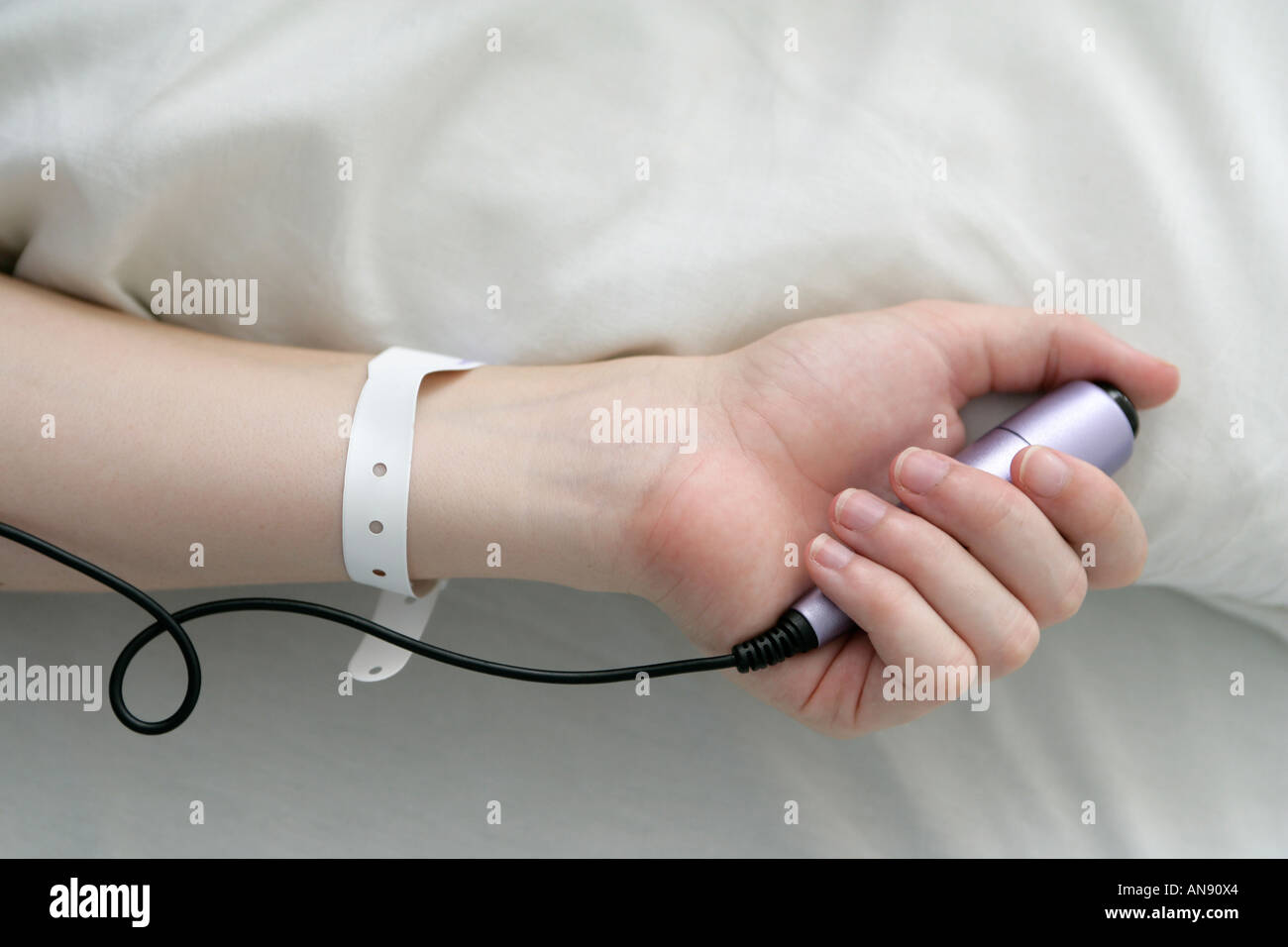 Woman using a tens machine in labour Stock Photo
