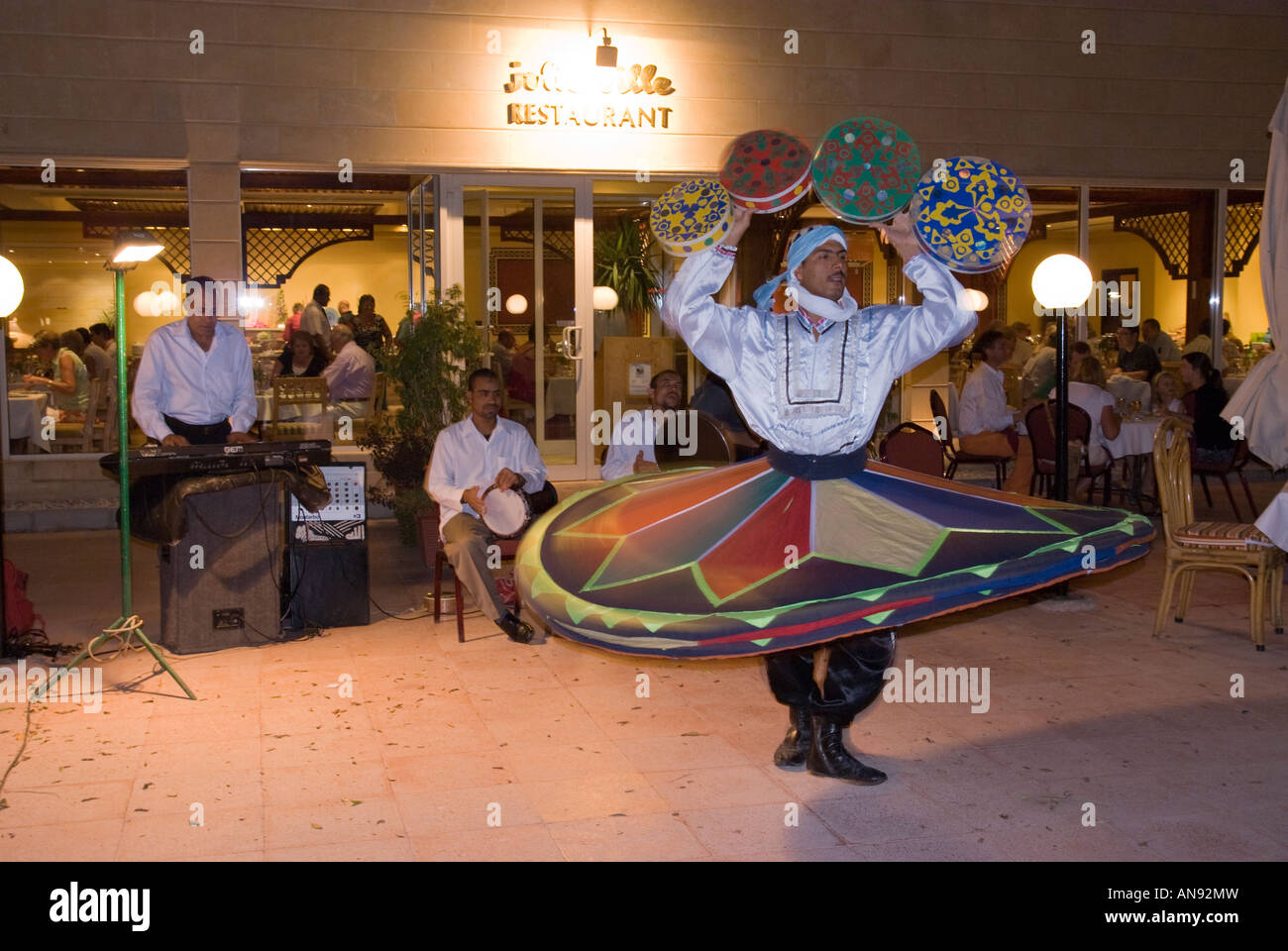 Egypt whirling dervish dancer entertains at Movenpick Jolie Ville hotel Crocodile Island on the Nile at Luxor Stock Photo