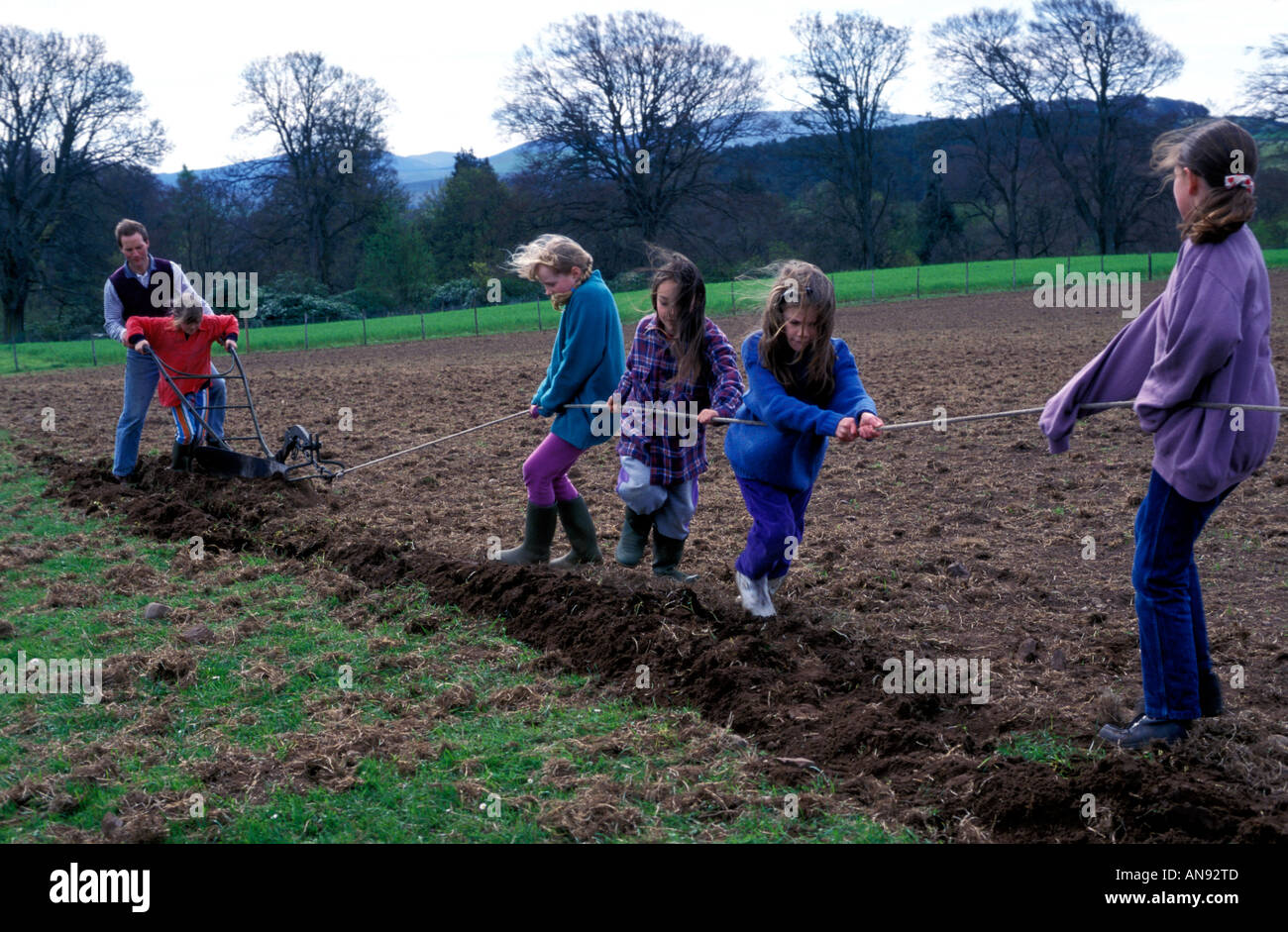 Children pulling a plough Stock Photo Alamy