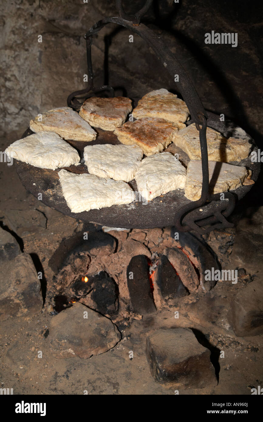 irish soda bread cooking on plate on traditional peat fire Stock Photo