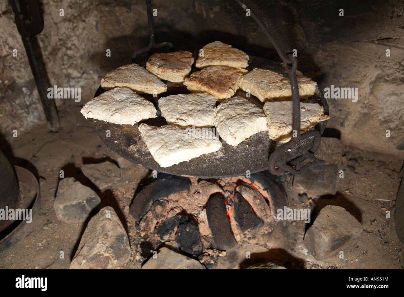 irish soda bread cooking on plate on traditional peat fire Stock Photo