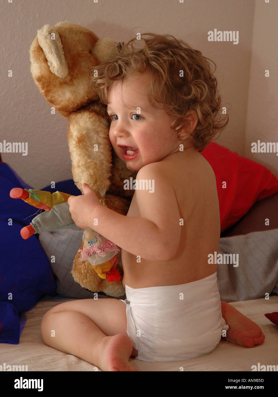 scared infant with a teddy bear Stock Photo