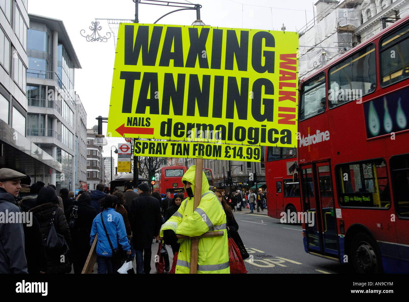 Christmas 2007 West End  London Oxford Street. Man with sandwich board offering waxing and tanning. Stock Photo