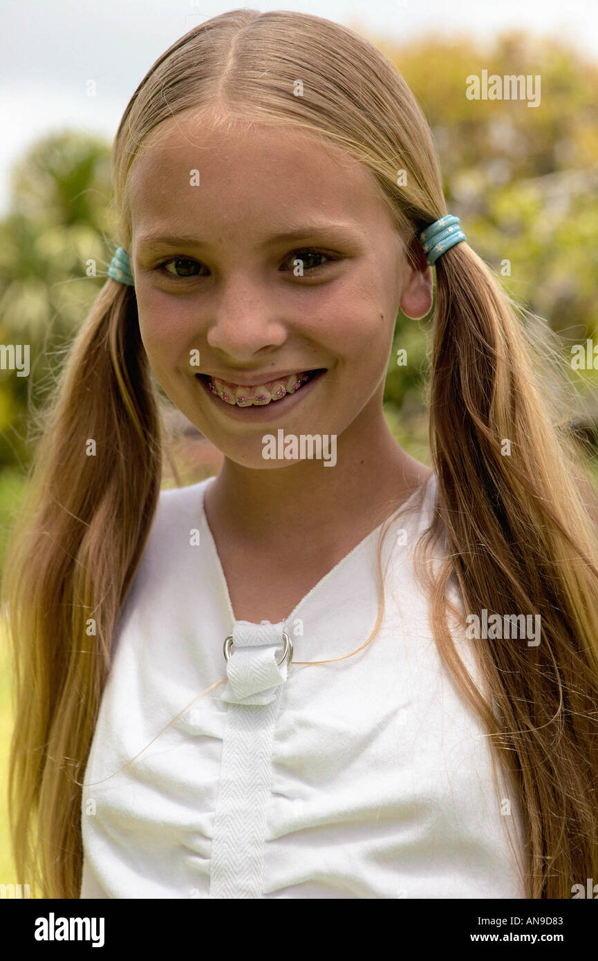Young girl smiling at camera Stock Photo - Alamy