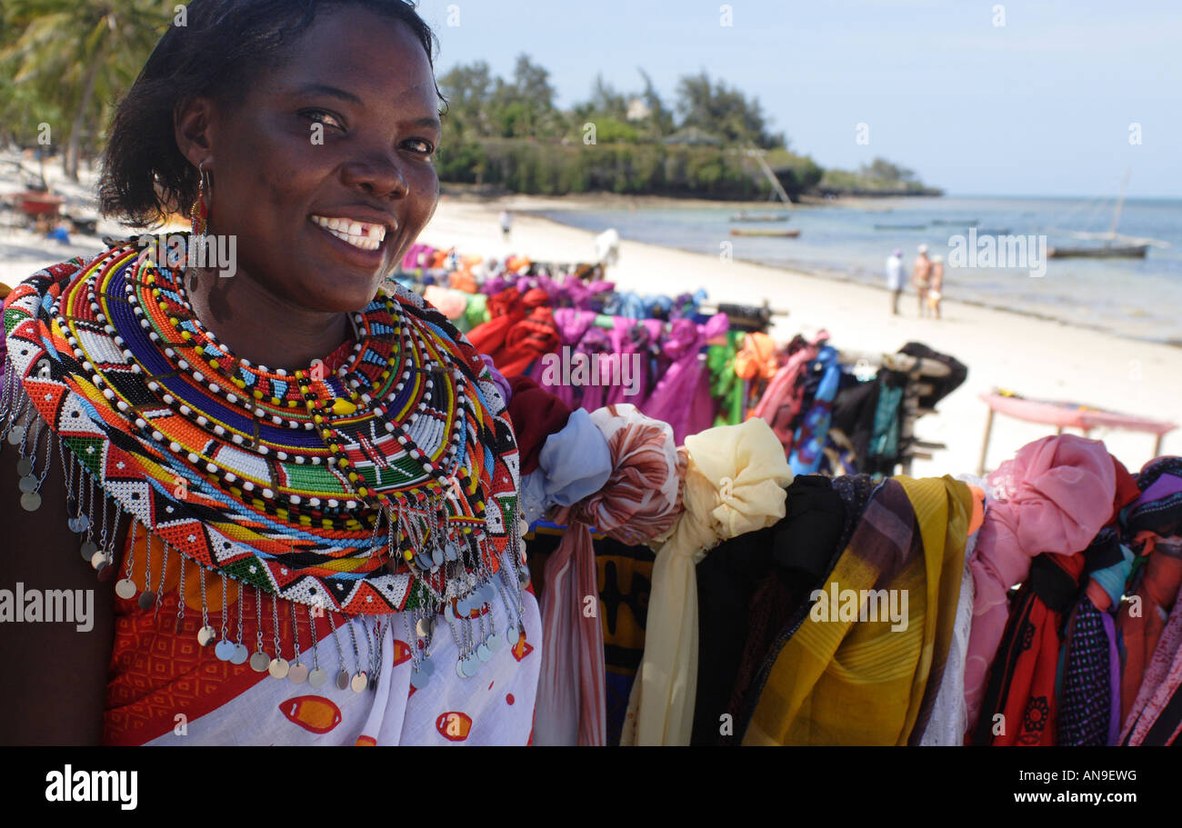Cheerful Masai fabric saleslady on Shanzu beach, Mombasa, Kenya Stock Photo