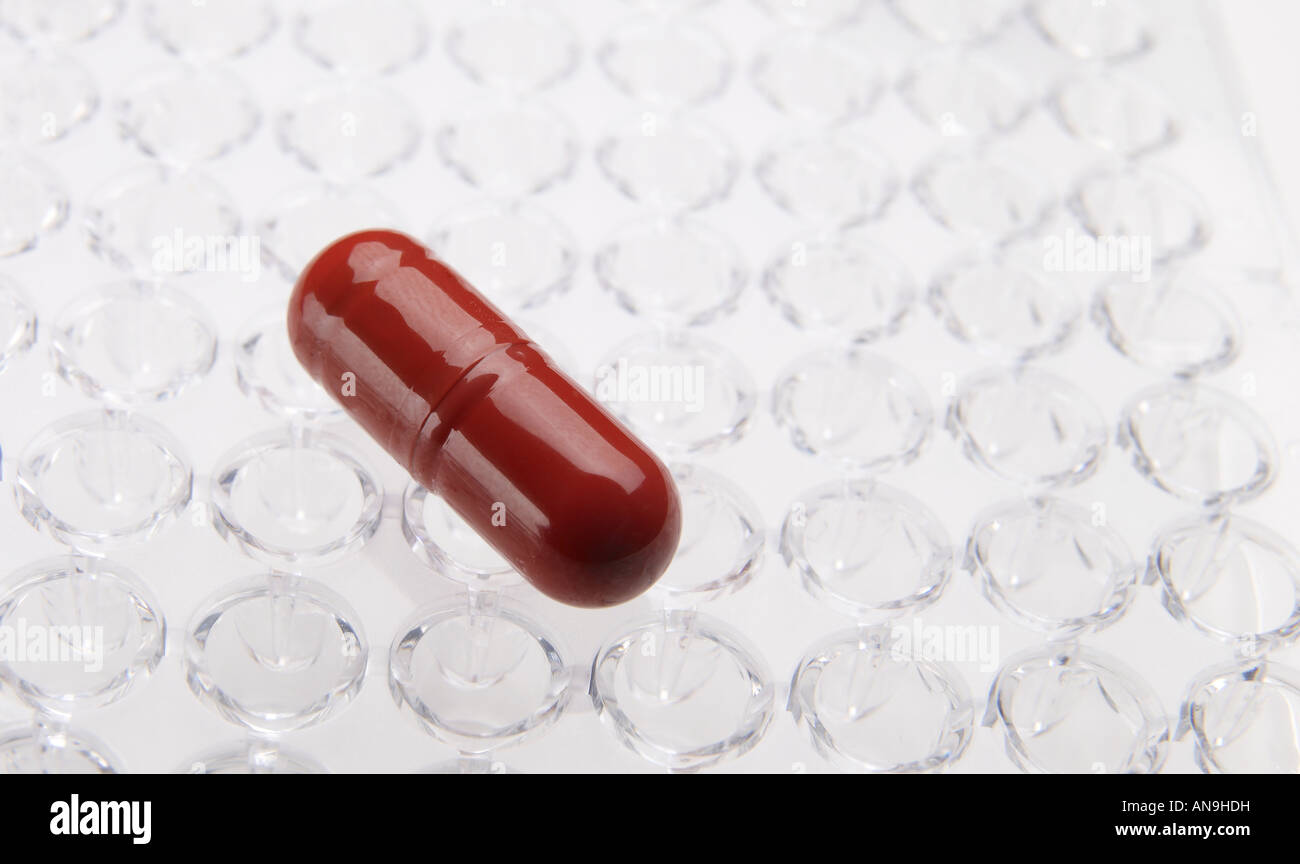 Single red capsule Stock Photo - Alamy