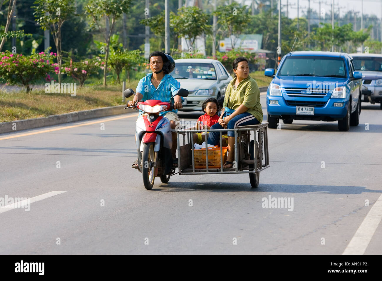 Family travel on a motorcycle and in a side trailer Bangkok Thailand Stock Photo