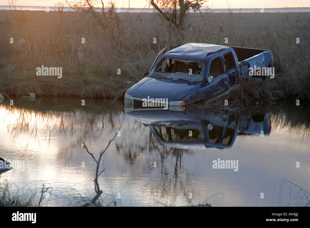 Damage  caused by Hurricane Katrina Near New Orleans Louisiana Blue truck stuck in flood waters Stock Photo