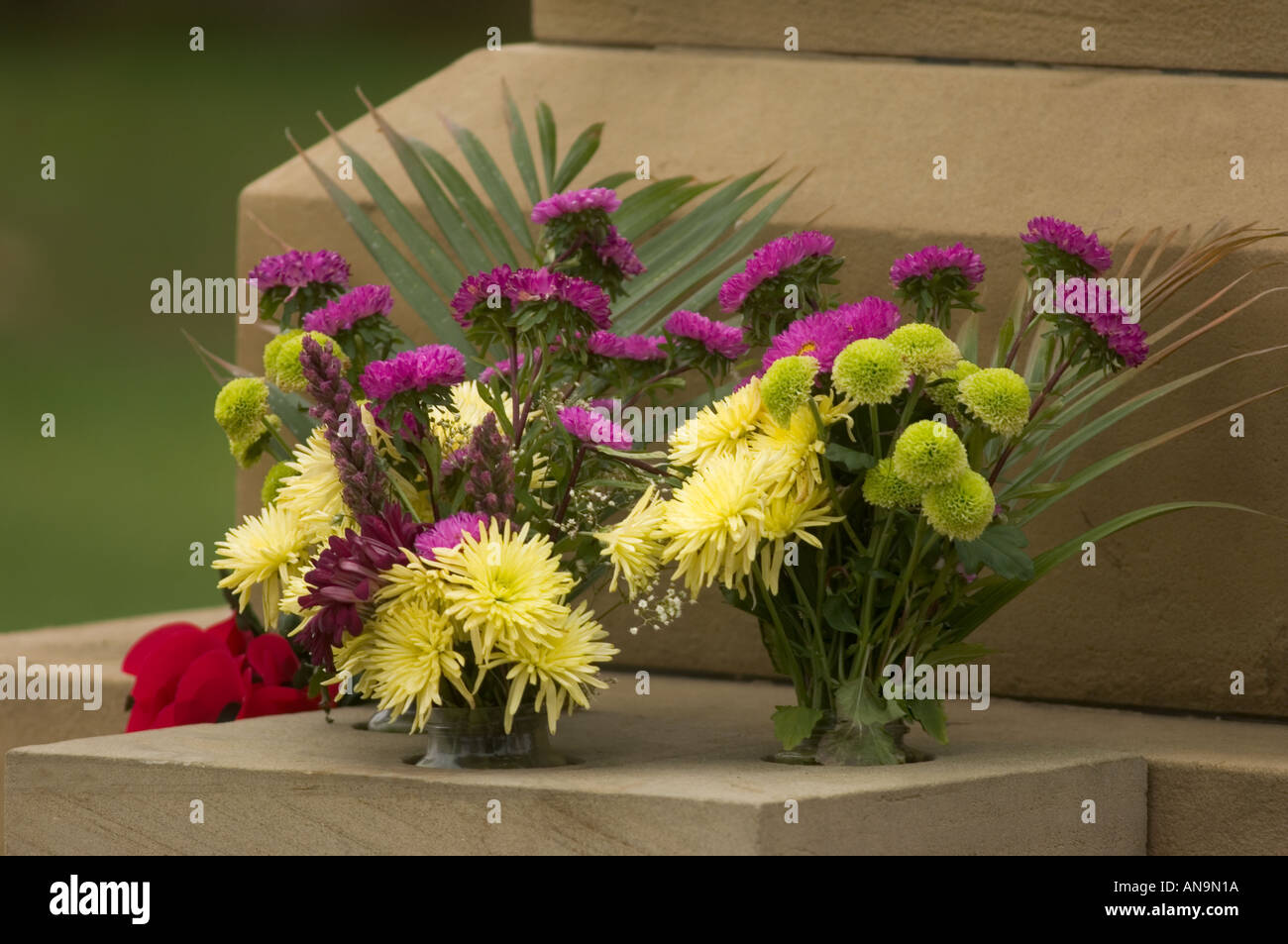 Wreath of flowers on a memorial statue in East Sussex UK Stock Photo