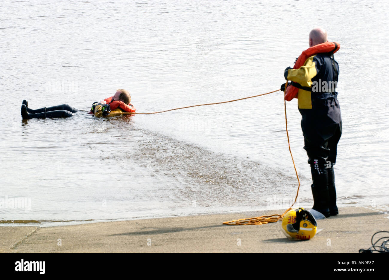 Firefighters on lifesaving drill in water at Swansea Marina South Wales ...