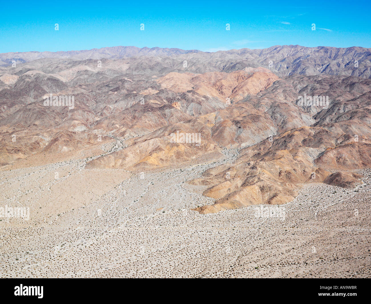 Aerial veiw of remote California desert with mountain range in background Stock Photo