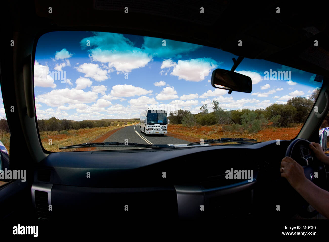 View of coach from interior of four wheel drive vehicle Red Centre Australia Stock Photo