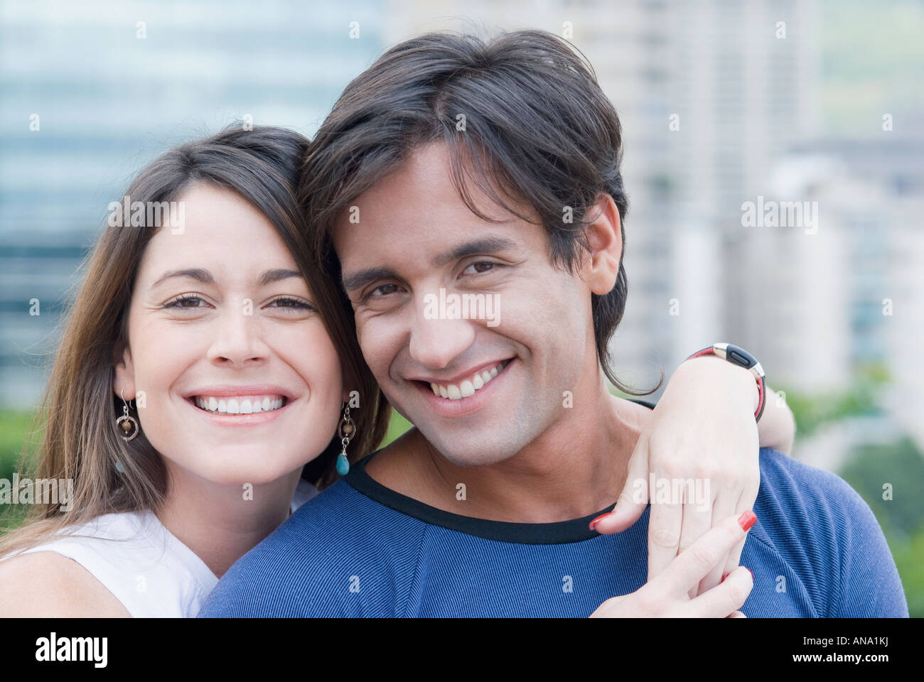 Hispanic couple hugging outdoors Stock Photo - Alamy
