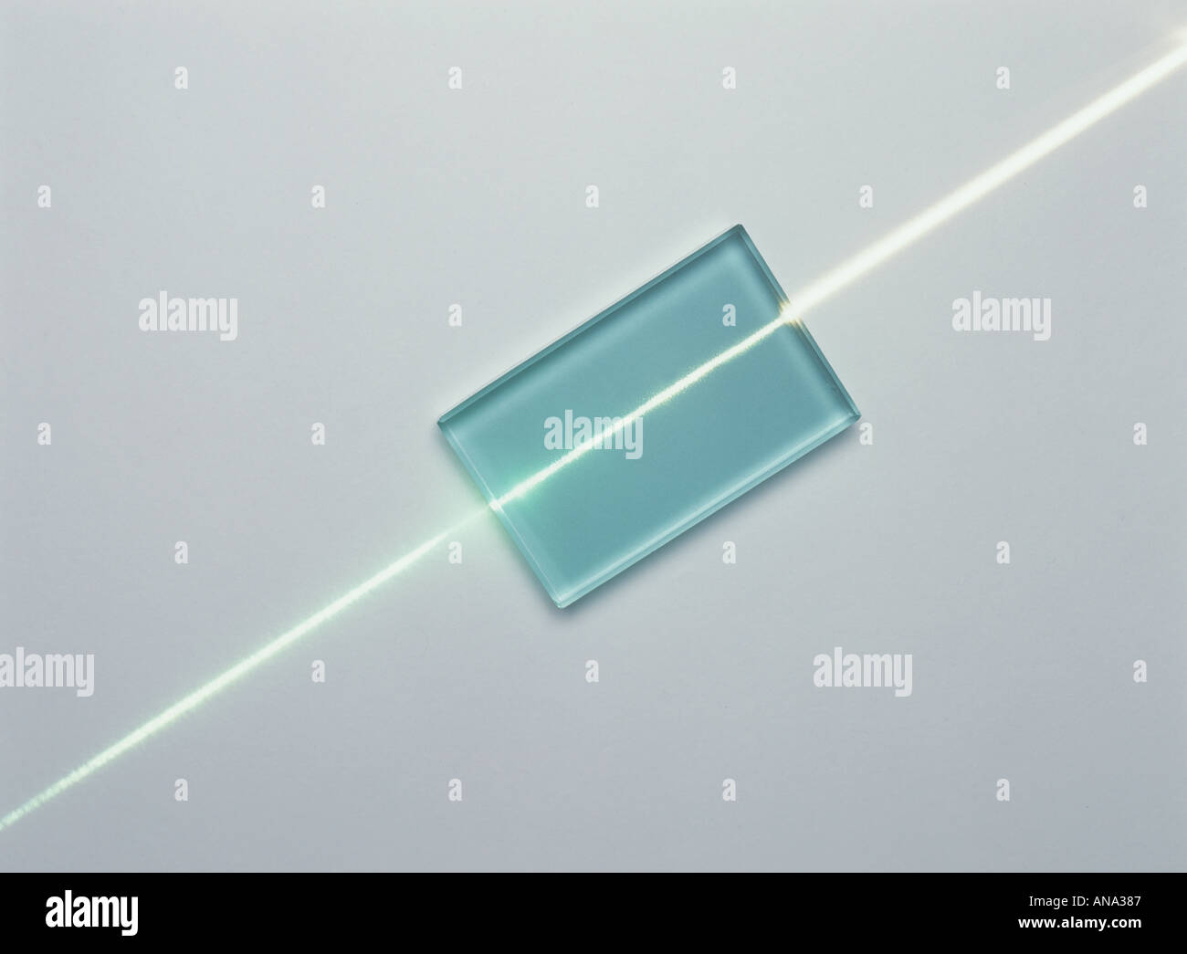 a ray of white light incident normally on a glass block is undeviated Stock Photo