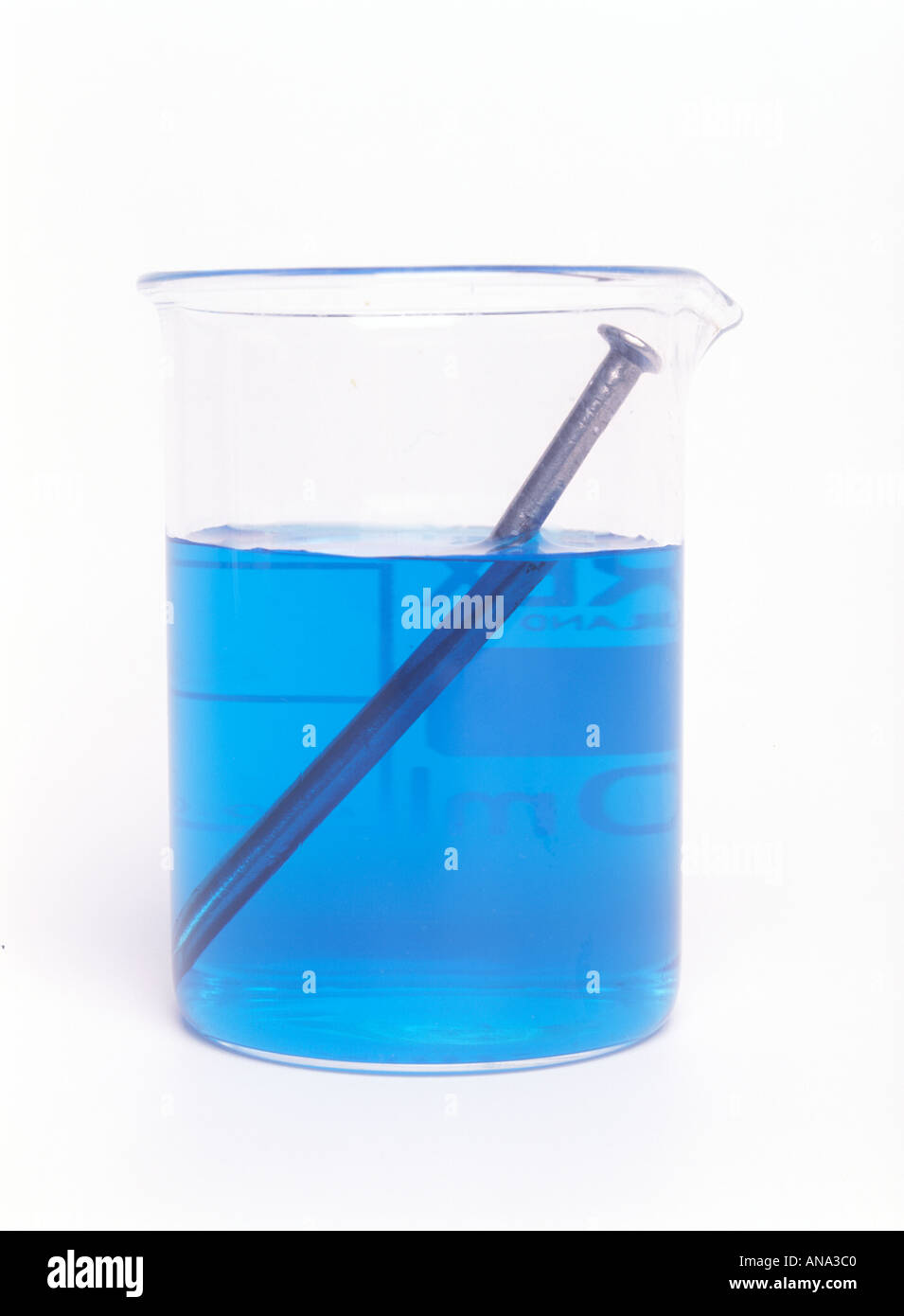 iron nail being copper plated by displacing copper from copper sulphate solution Stock Photo