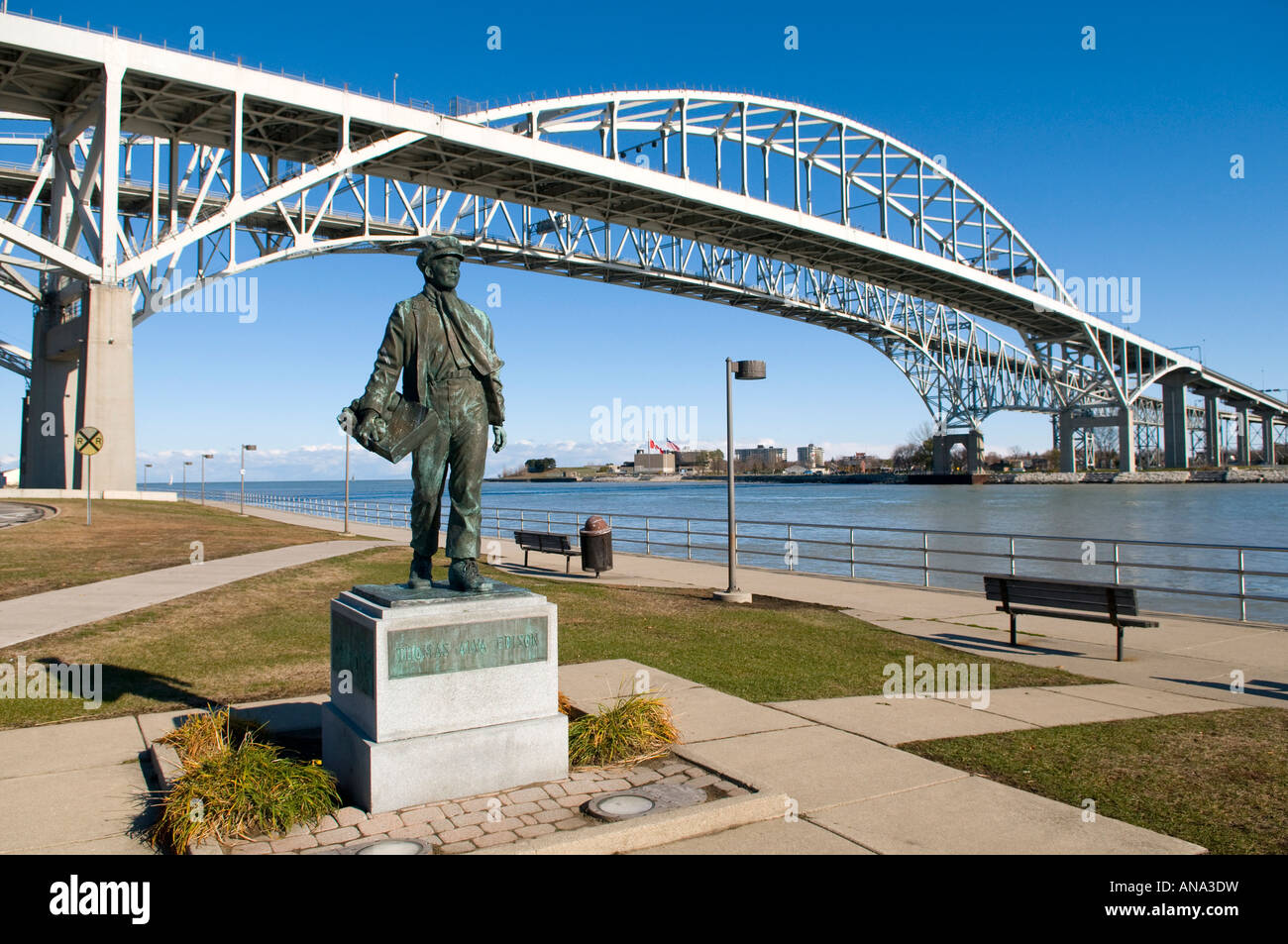 Thomas Edison Statue at boyhood home of Port Huron Michigan with Blue Water International Bridge to Canada in view Stock Photo
