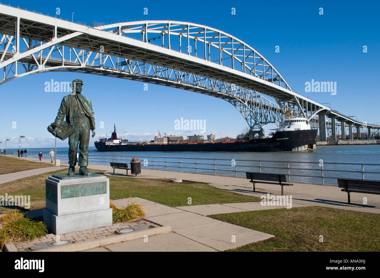 Thomas Edison Statue at boyhood home of Port Huron Michigan with Blue Water International Bridge to Canada in view Stock Photo