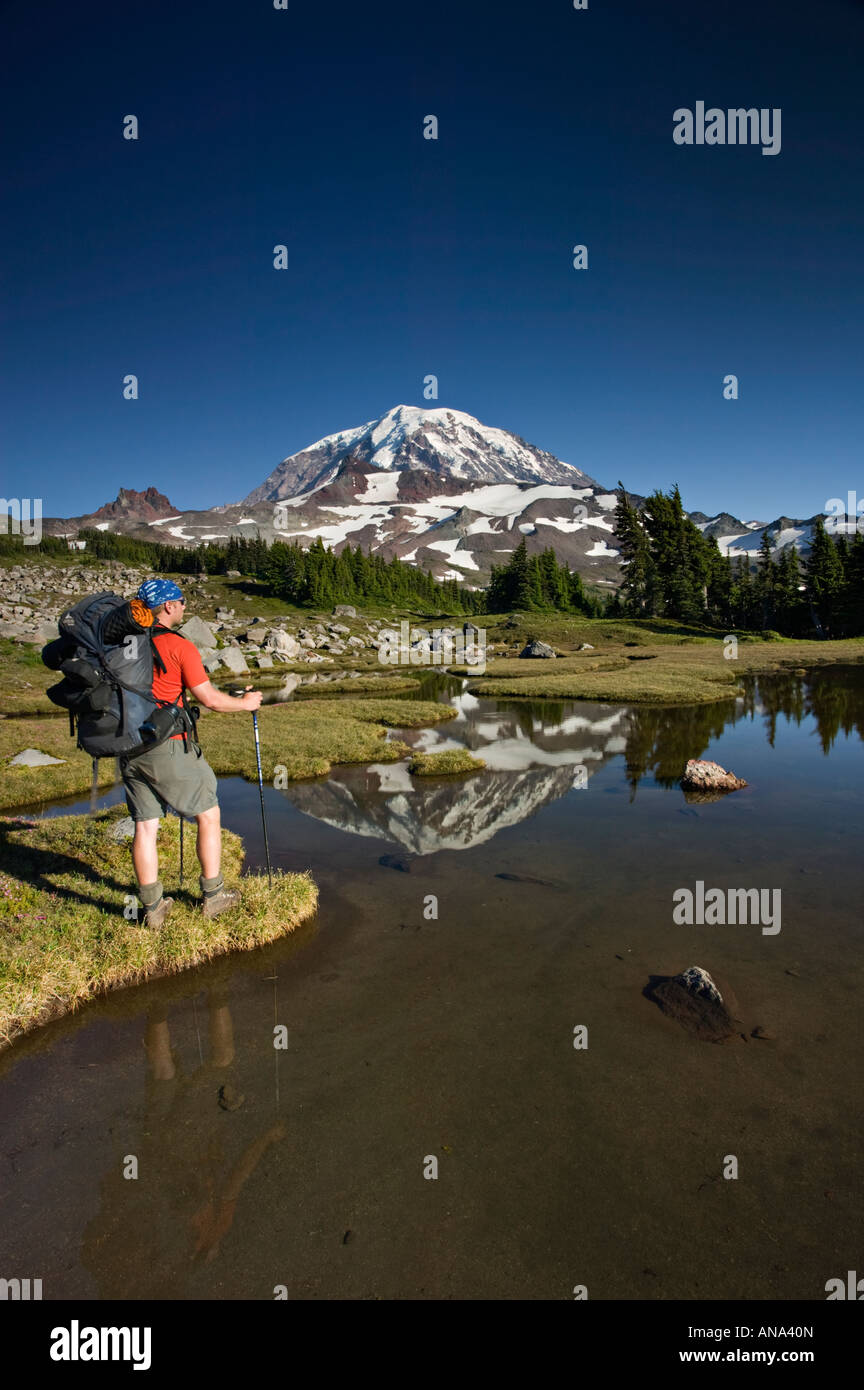 Backpacker and Mt Rainier reflection Stock Photo - Alamy