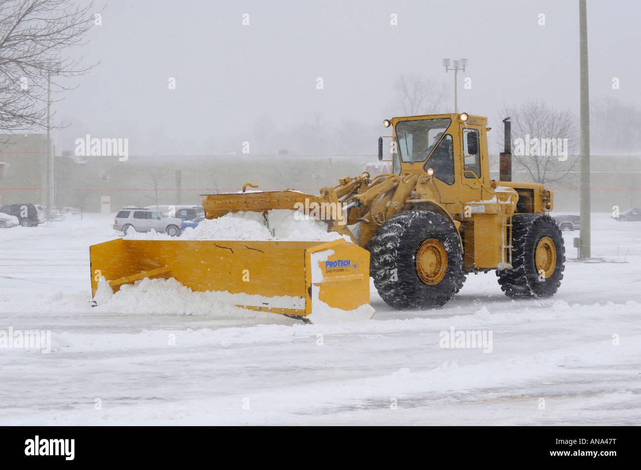 Snow plow busy clearing streets and roads during Winter season in the
