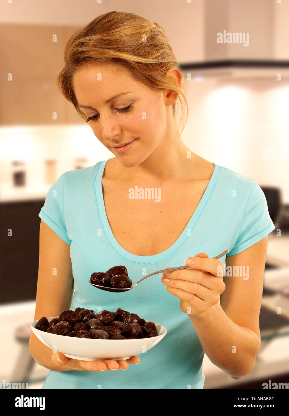 WOMAN EATING PRUNES Stock Photo Alamy