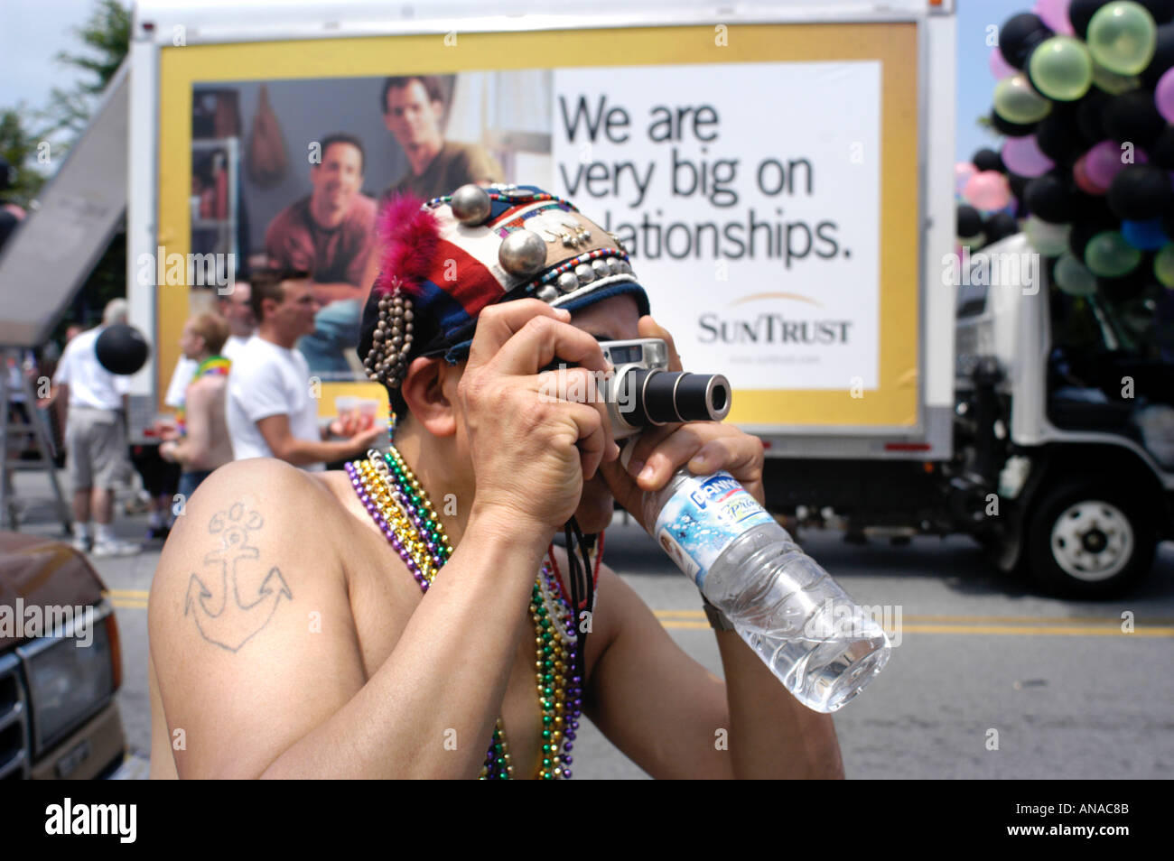 White queer man taking photos at Gay Pride Parade in Atlanta 