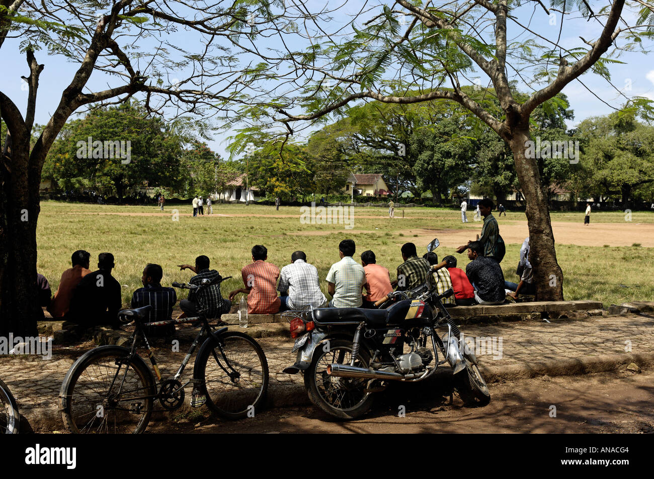 Boys watch a cricket game in Fort Kochin Stock Photo